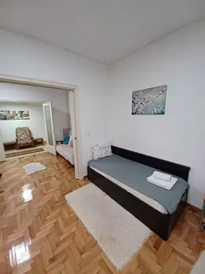a bedroom with a large bed and a wooden floor at Spacious Apartment 2 minutes from Omonoia Metro in Athens