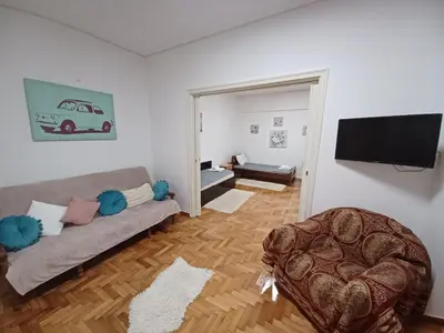 a living room with a couch and a flat screen tv at Spacious Apartment 2 minutes from Omonoia Metro in Athens
