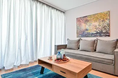 a living room with a couch and a table at Comfortable Apartment, close to Piraeus Port SPC2 in Piraeus