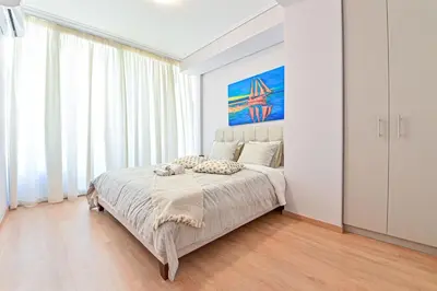 a bedroom with a bed with a large window at Comfortable Apartment, close to Piraeus Port SPC2 in Piraeus