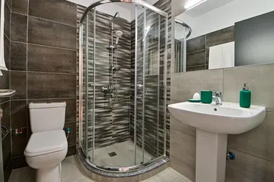 a bathroom with a shower and a toilet and a sink at Comfortable Apartment, close to Piraeus Port SPC2 in Piraeus
