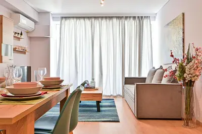 a kitchen and living room with a table and a couch at Comfortable Apartment, close to Piraeus Port SPC2 in Piraeus