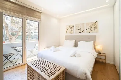 a bedroom with two beds and a balcony at Parkside Kolonaki in Athens