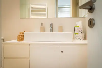a bathroom with a white sink and a mirror at Parkside Kolonaki in Athens