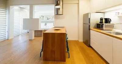 a kitchen with a wooden counter and a refrigerator at Parkside Kolonaki in Athens