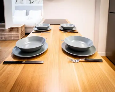 a table with four plates and utensils on it at Parkside Kolonaki in Athens