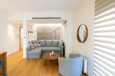 a living room with a blue couch and a table at Parkside Kolonaki in Athens