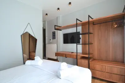 a bedroom with a large bed and a tv at Modern two bedroom apartment Stili Olympioy Dios in Athens