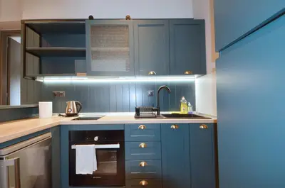 a kitchen with blue cabinets and a sink at Modern two bedroom apartment Stili Olympioy Dios in Athens