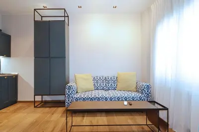 a living room with a couch and a table at Modern two bedroom apartment Stili Olympioy Dios in Athens