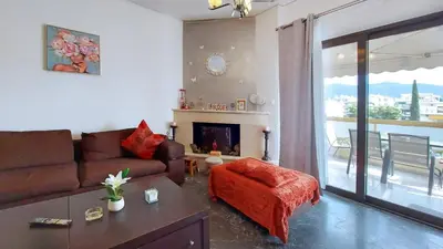 a living room with a couch and a fireplace at Cholargos a Spacious 2BR apartment with great view in Athens