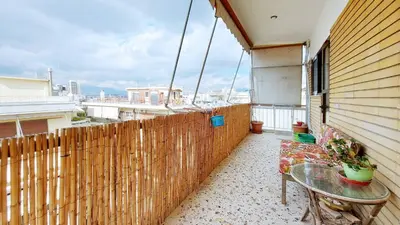 a balcony with a glass table and a fence at Cholargos a Spacious 2BR apartment with great view in Athens