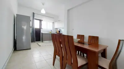 a kitchen with a table and chairs and a refrigerator at Cholargos a Spacious 2BR apartment with great view in Athens