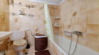 a bathroom with a tub and a toilet and a sink at Cholargos a Spacious 2BR apartment with great view in Athens