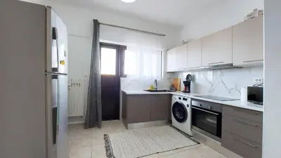 a kitchen with a refrigerator and a dishwasher at Cholargos a Spacious 2BR apartment with great view in Athens