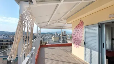 a balcony with a view of a city at A bright and relaxing penthouse on the 5th floor in Athens