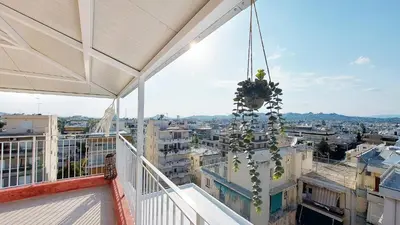 a view of a city from the balcony of a building at A bright and relaxing penthouse on the 5th floor in Athens
