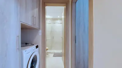 a bathroom with a washing machine and a shower at A modern and bright apartment in Kolonaki in Athens