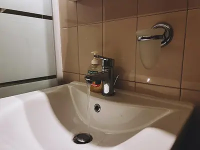 a sink in a bathroom with a faucet at Budget and private flat in Aristotelous in Athens
