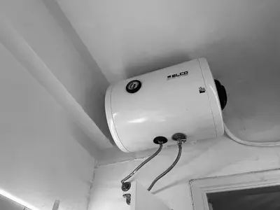 a toilet tank on the ceiling of a bathroom at Budget and private flat in Aristotelous in Athens