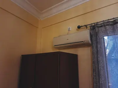 a bathroom with a air conditioner on the wall at Budget and private flat in Aristotelous in Athens