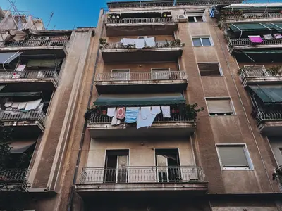 an apartment building with clothes hanging on the balconies at Budget and private flat in Aristotelous in Athens