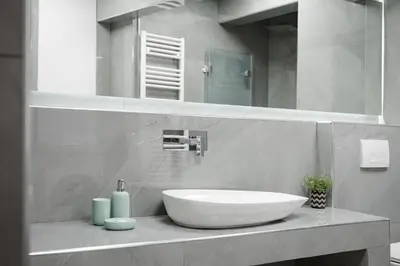 a bathroom with a white sink and a mirror at Acropolis Secret Apartment in Athens