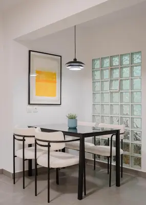 a dining room with a black table and white chairs at Acropolis Secret Apartment in Athens
