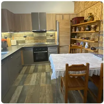 a kitchen with a table and a table and chairs at Aegean Home in Áyios Nikólaos