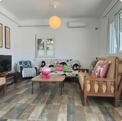 a living room with a couch and a table at Aegean Home in Áyios Nikólaos