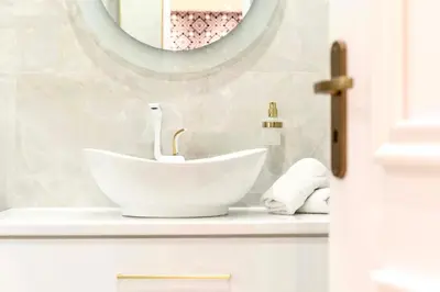 a bathroom with a white sink and a mirror at Athens Acropolis Markella in Athens