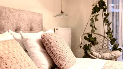 a bedroom with a bed with pillows and a chair at Athens Acropolis Markella in Athens