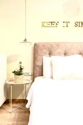 a bedroom with a bed and a sign that says keep it simple at Athens Acropolis Markella in Athens