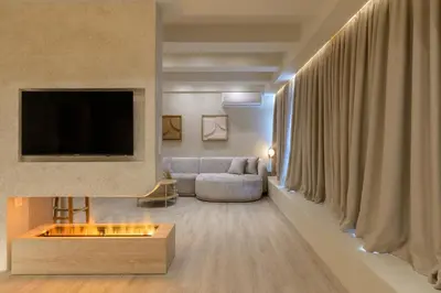 a living room with a couch and a tv at Minimalist Oasis in Athens in Athens