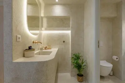 a bathroom with a sink and a toilet and a mirror at Minimalist Oasis in Athens in Athens