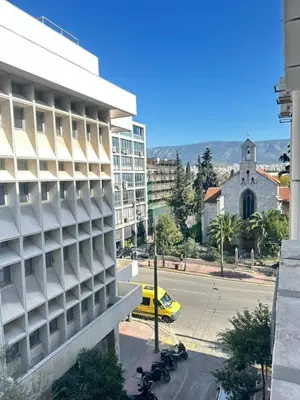 a building with motorcycles parked in front of a street at Minimalist Oasis in Athens in Athens