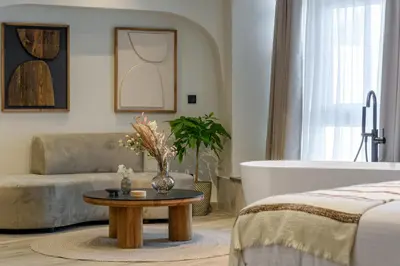 a living room with a bed and a bath tub at Urban Serenity Suite in Athens in Athens