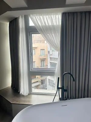 a large window with a view of a building at Urban Serenity Suite in Athens in Athens