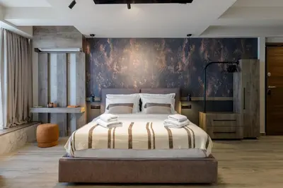 a bedroom with a large bed and a wall at Urban Serenity Suite in Athens in Athens