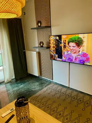 a room with a flat screen tv on the wall at New Delightful Apartment in Athens