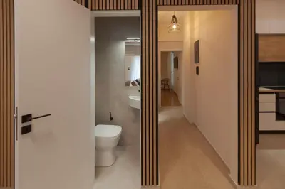 a bathroom with a toilet and a sink at Phaedrus Living Athens Metsovou Residence in Athens