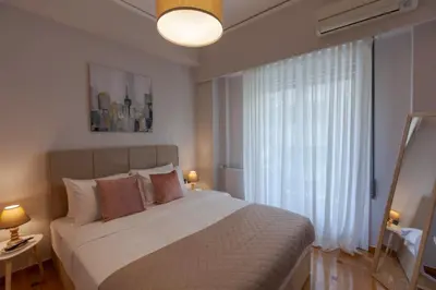 a bedroom with a large bed and a large window at Phaedrus Living Athens Metsovou Residence in Athens