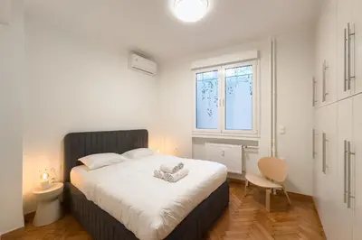 a bedroom with a large white bed in a room at New Central Apt in Kolonaki in Athens