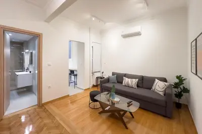 a living room with a couch and a table at New Central Apt in Kolonaki in Athens