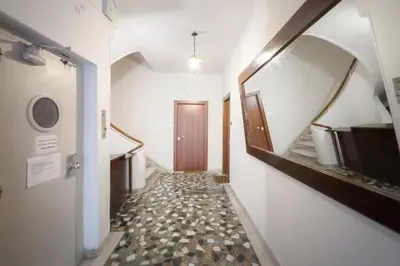 a hallway with a door and a walkway at New Central Apt in Kolonaki in Athens