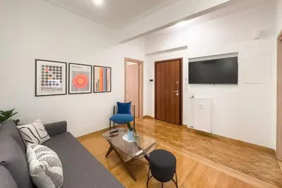 a living room with a couch and a tv at New Central Apt in Kolonaki in Athens