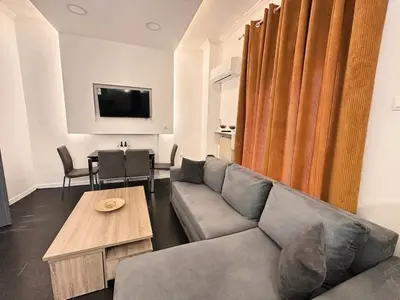 a living room with a couch and a table at Gazi Square Apartment in Athens