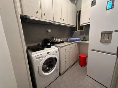 a kitchen with a washing machine and a refrigerator at Gazi Square Apartment in Athens