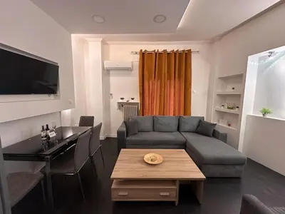 a living room with a couch and a table at Gazi Square Apartment in Athens
