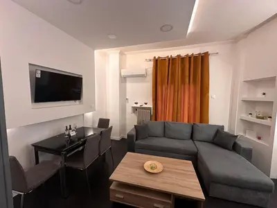 a living room with a couch and a table at Gazi Square Apartment in Athens